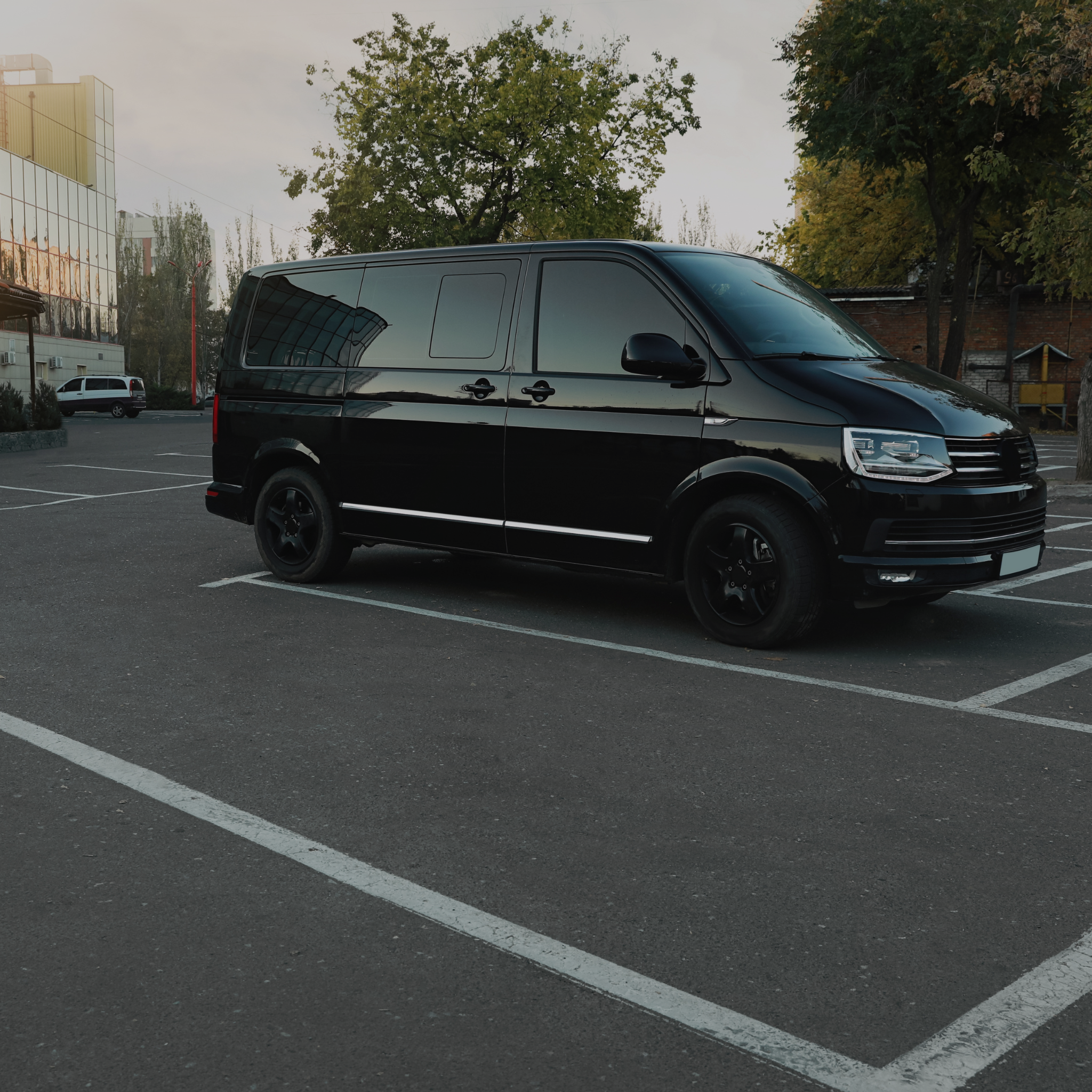Black Sprinter van party bus style parked in the parking lot